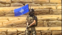 [RU$L]  Attach (NATO) flag to nearest man